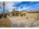 A view of the rear exterior of the home showing the backyard and detached garage at 418 E 3Rd St, Casa Grande, AZ 85122