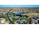 Scenic aerial shot showcases a golf course, lake with fountains, and a well-planned community at 42735 W Bravo Dr, Maricopa, AZ 85138