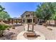 Well-maintained backyard with decorative water feature, gazebo, and lush trees at 42735 W Bravo Dr, Maricopa, AZ 85138