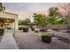 Backyard with a stone walkway leading to a gazebo and outdoor fireplace at 42735 W Bravo Dr, Maricopa, AZ 85138