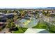 Community basketball court surrounded by mature trees and well-maintained landscaping in a residential area at 42735 W Bravo Dr, Maricopa, AZ 85138