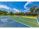 Outdoor basketball court with bright blue, green and yellow surface in a well-maintained neighborhood at 42735 W Bravo Dr, Maricopa, AZ 85138
