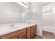 Bathroom featuring a double sink vanity with modern lighting and a large mirror at 42735 W Bravo Dr, Maricopa, AZ 85138