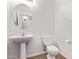 Bathroom featuring pedestal sink, toilet, and neutral color palette at 42735 W Bravo Dr, Maricopa, AZ 85138