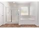 Bright bathroom boasts a walk-in shower, a soaking tub, and tiled floors at 42735 W Bravo Dr, Maricopa, AZ 85138