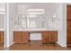 Bathroom featuring a double vanity with lots of counter space, a large mirror, and modern lighting at 42735 W Bravo Dr, Maricopa, AZ 85138