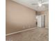Bright bedroom features neutral walls, carpet flooring, and access to an ensuite bathroom and walk-in closet at 42735 W Bravo Dr, Maricopa, AZ 85138