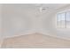 Bedroom features neutral carpet, a window, and a ceiling fan at 42735 W Bravo Dr, Maricopa, AZ 85138