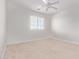 Bright bedroom features neutral carpet and a ceiling fan at 42735 W Bravo Dr, Maricopa, AZ 85138