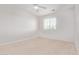 Bedroom features neutral carpet, a window, and a ceiling fan at 42735 W Bravo Dr, Maricopa, AZ 85138