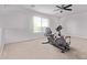 Upstairs bonus room with stationary bike, carpeted floors and ceiling fan at 42735 W Bravo Dr, Maricopa, AZ 85138