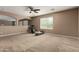 Large carpeted bonus room with ceiling fan and abundant natural light at 42735 W Bravo Dr, Maricopa, AZ 85138