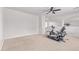 Upstairs bonus room with stationary bike, neutral carpet and archways at 42735 W Bravo Dr, Maricopa, AZ 85138
