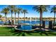 Picturesque lake with palm trees, fountains, and lush green landscaping for a peaceful community setting at 42735 W Bravo Dr, Maricopa, AZ 85138
