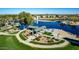 Community park featuring green space, picnic tables, a fountain, and a splash pad, perfect for outdoor gatherings at 42735 W Bravo Dr, Maricopa, AZ 85138