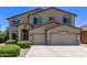 Charming two-story home featuring a three-car garage and well-maintained front landscaping at 42735 W Bravo Dr, Maricopa, AZ 85138