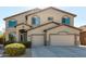 Charming two-story home with a three-car garage and inviting covered entryway at 42735 W Bravo Dr, Maricopa, AZ 85138