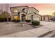 Desert landscaped home with a two-story elevation, three-car garage and covered entry at 42735 W Bravo Dr, Maricopa, AZ 85138