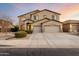 Two-story home with a desert landscaped front yard and three-car garage at 42735 W Bravo Dr, Maricopa, AZ 85138