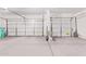 Spacious two-car garage featuring automatic door openers, and concrete floors at 42735 W Bravo Dr, Maricopa, AZ 85138