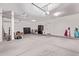 View of a large garage with concrete floors, good storage and organization at 42735 W Bravo Dr, Maricopa, AZ 85138