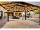 Gazebo in backyard with string lights and a stone patio at 42735 W Bravo Dr, Maricopa, AZ 85138