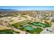 Aerial view of community golf course with multiple greens, ponds, and manicured landscaping at 42735 W Bravo Dr, Maricopa, AZ 85138