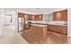 Bright kitchen boasts stainless appliances, center island, and tiled floors at 42735 W Bravo Dr, Maricopa, AZ 85138