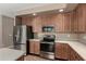 Kitchen with stainless steel appliances, ample cabinet space, and tile flooring at 42735 W Bravo Dr, Maricopa, AZ 85138
