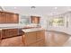 Kitchen featuring stainless steel appliances, center island, and tile flooring at 42735 W Bravo Dr, Maricopa, AZ 85138