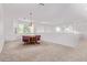Upstairs living area with table and chairs, carpeted floors and lots of natural light at 42735 W Bravo Dr, Maricopa, AZ 85138