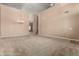 Large living room with soaring ceilings, neutral carpet, chandelier and open access to the home at 42735 W Bravo Dr, Maricopa, AZ 85138
