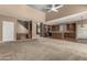 Open concept living room with soaring ceilings, a ceiling fan, and view of the kitchen at 42735 W Bravo Dr, Maricopa, AZ 85138