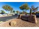 Stone signage marking 'Jane Askew Memorial Park' near a parking area, landscaped with desert plants and trees at 42735 W Bravo Dr, Maricopa, AZ 85138