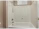 A bright white shower and tub combo with a shower head and window at 42735 W Bravo Dr, Maricopa, AZ 85138