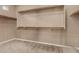 Large walk-in closet with multiple shelves for organized storage at 42735 W Bravo Dr, Maricopa, AZ 85138