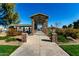 Picturesque walkway and picnic area with stone pillars, leading to a scenic lake view in a well-maintained community park at 42735 W Bravo Dr, Maricopa, AZ 85138