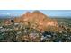 Stunning aerial view showcasing the community nestled at the base of picturesque red rock formations, near the mountains at 4306 E Flower St, Phoenix, AZ 85018