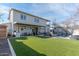 Spacious backyard with a covered patio, lush grass, an outdoor kitchen and a swimming pool at 4306 E Flower St, Phoenix, AZ 85018