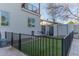 Enclosed backyard featuring a low-maintenance lawn area and secure black metal fencing at 4306 E Flower St, Phoenix, AZ 85018