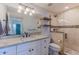 Updated bathroom featuring granite counters, double vanity, and a tiled glass shower at 4306 E Flower St, Phoenix, AZ 85018
