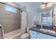 Tiled bathroom with a shower-tub combination and modern fixtures and decor at 4306 E Flower St, Phoenix, AZ 85018