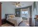 Comfortable bedroom with warm tones, plush bedding, and natural light, and a ceiling fan at 4306 E Flower St, Phoenix, AZ 85018
