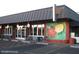 Attractive restaurant exterior featuring ample parking, outdoor seating, and a charming mural that attracts visitors at 4306 E Flower St, Phoenix, AZ 85018
