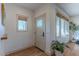 Bright foyer with wood floors, a stylish front door with glass, and natural light at 4306 E Flower St, Phoenix, AZ 85018