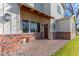 Inviting front porch with brickwork, exposed wood beams, and a wooden front door at 4306 E Flower St, Phoenix, AZ 85018