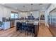 A modern kitchen featuring white cabinets, stainless steel appliances, and a large island with bar seating at 4306 E Flower St, Phoenix, AZ 85018