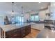 Bright kitchen features an island with granite countertop, modern appliances, and wood floors at 4306 E Flower St, Phoenix, AZ 85018