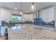 Spacious kitchen with white cabinets, an oversized island, and elegant countertops at 4306 E Flower St, Phoenix, AZ 85018