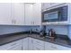 Well-lit kitchen corner showcases gray countertops, white cabinets, and stainless steel microwave at 4306 E Flower St, Phoenix, AZ 85018